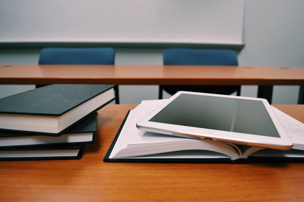 Tablet and Books on a Desk